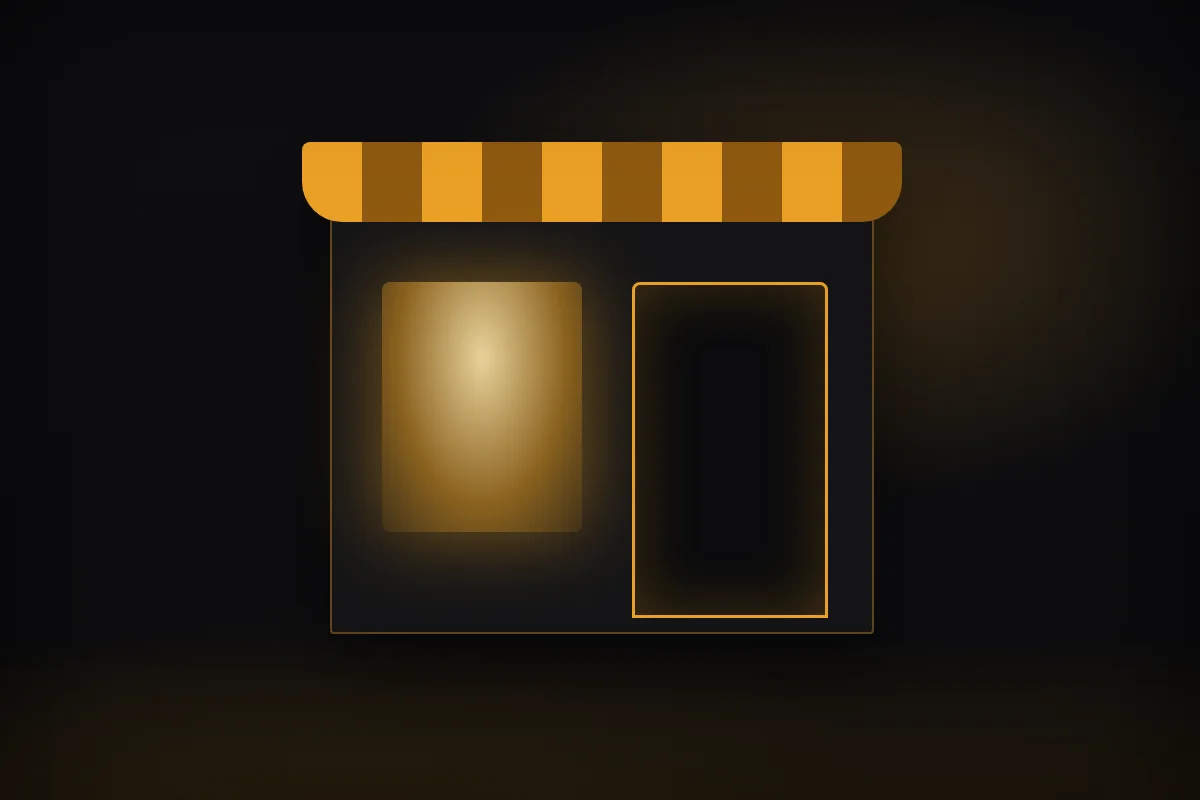 A small shop front glowing at night on an empty street